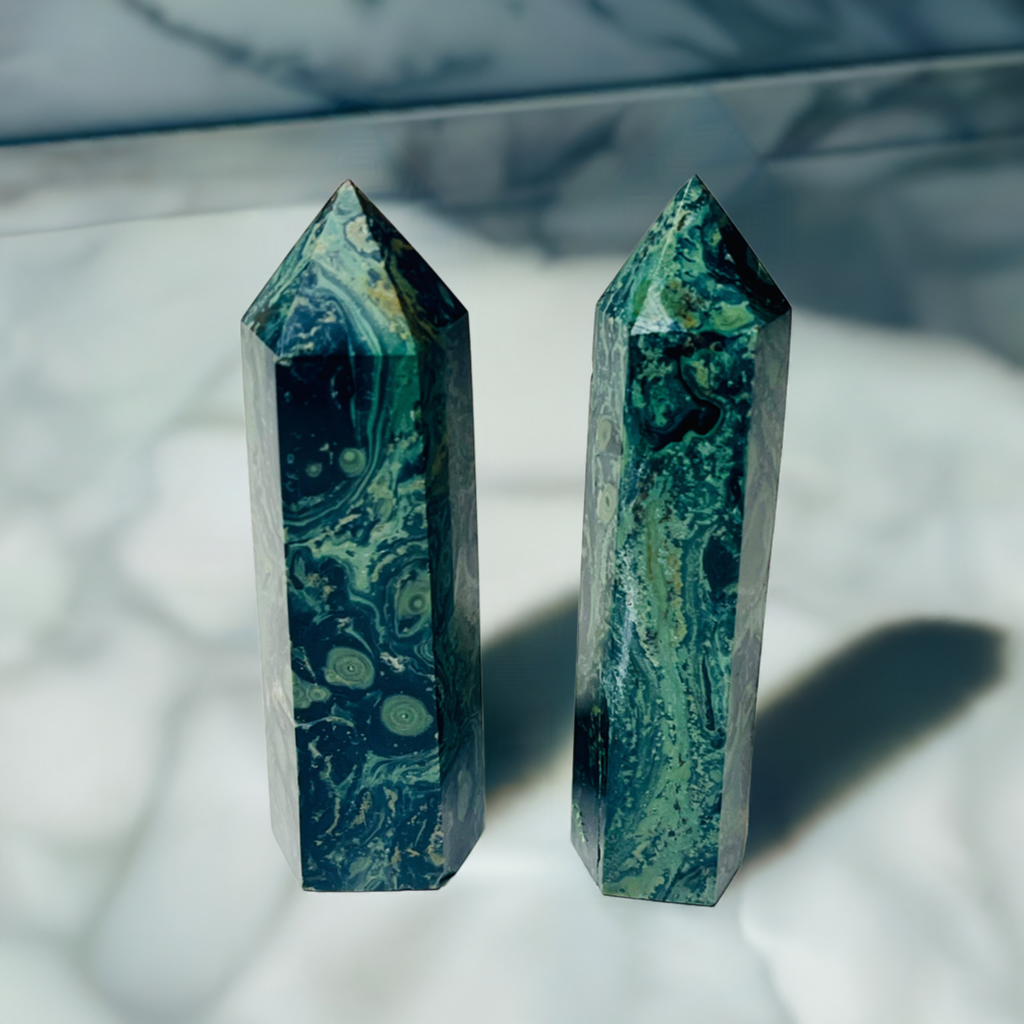 2 kambaba jasper healing crystal points on a marble table