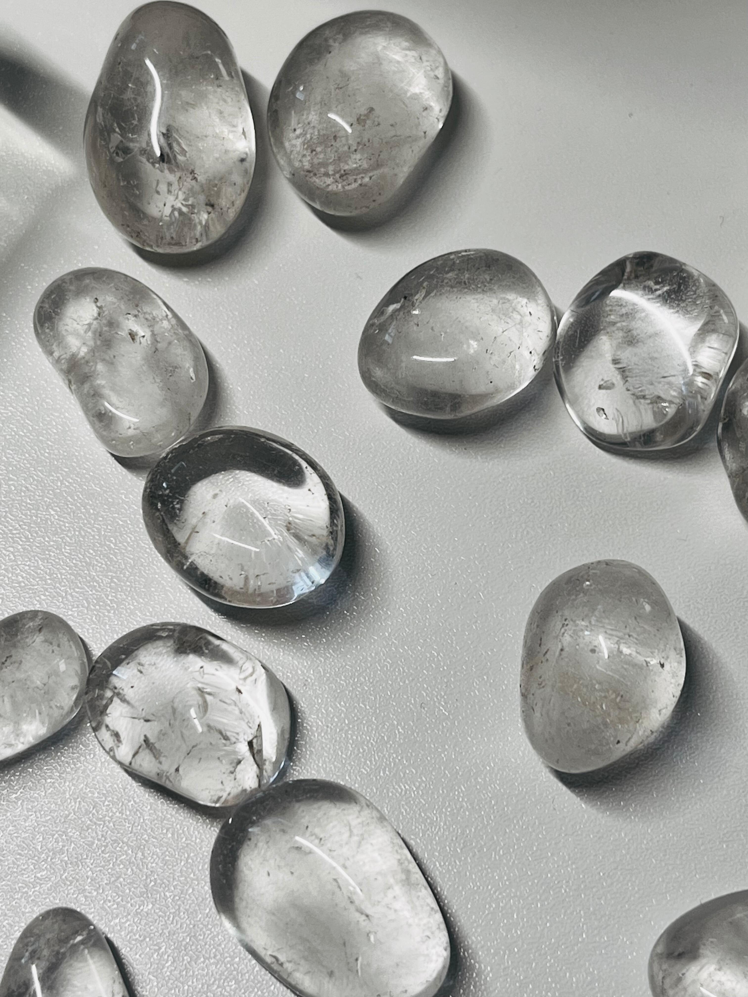 Clear Quartz Tumbles Stones on a white table