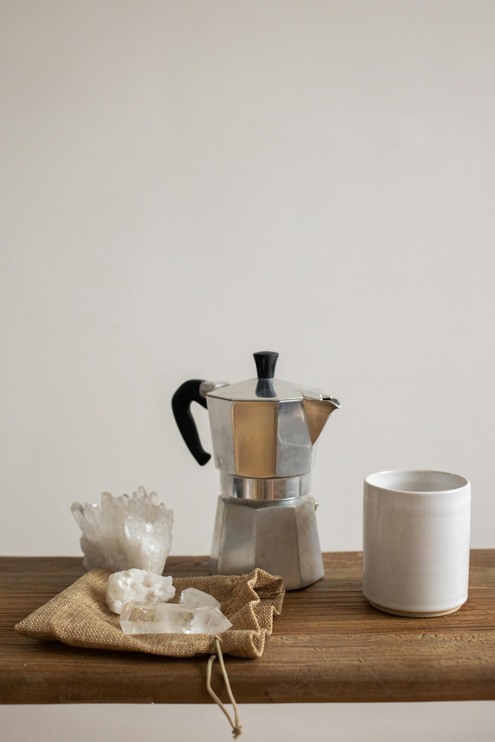 crystals next to a coffee maker and mug in th kitchen