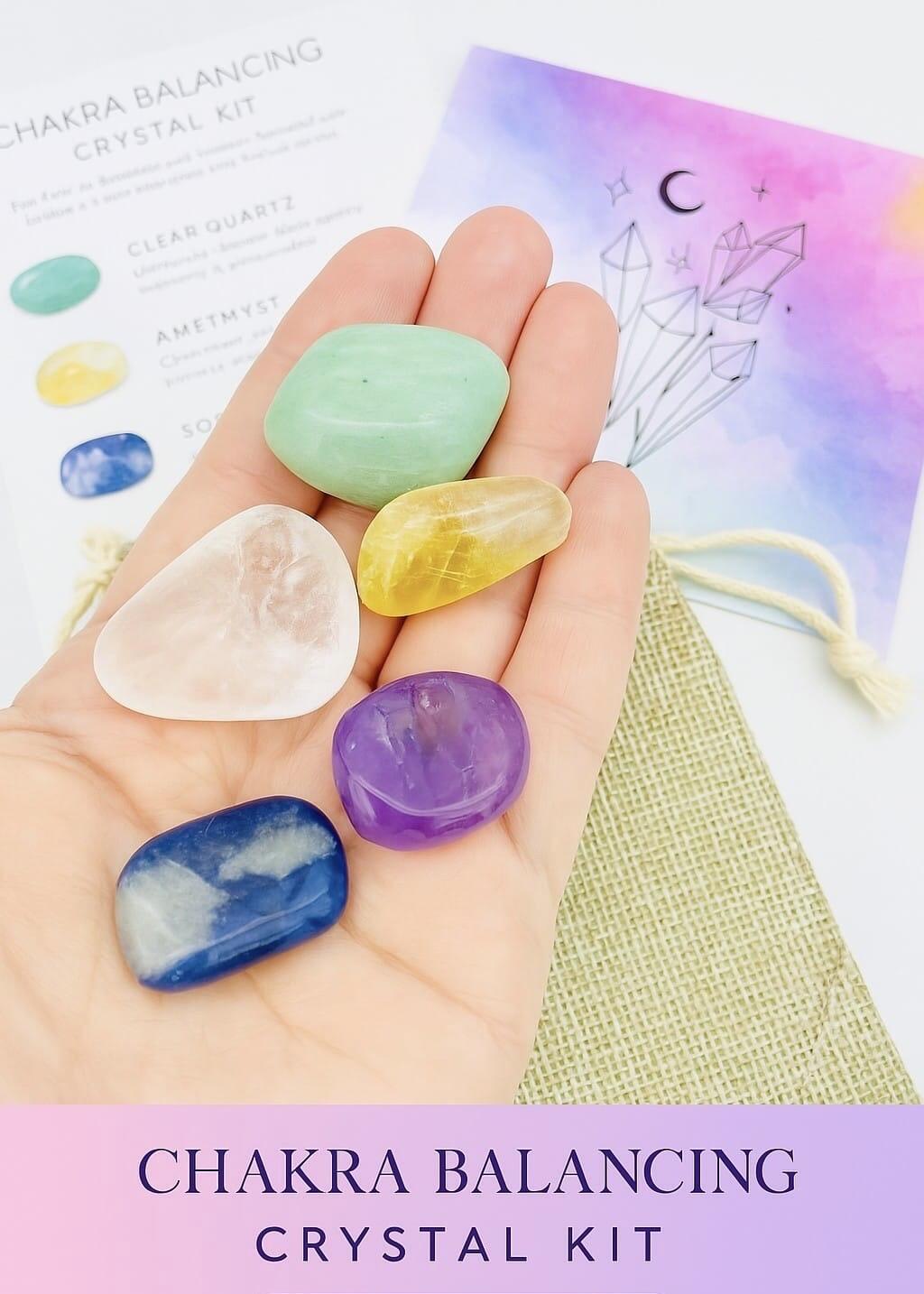 Chakra Alignment Crystal Kit balancing tools, five crystals held in the palm of a hand