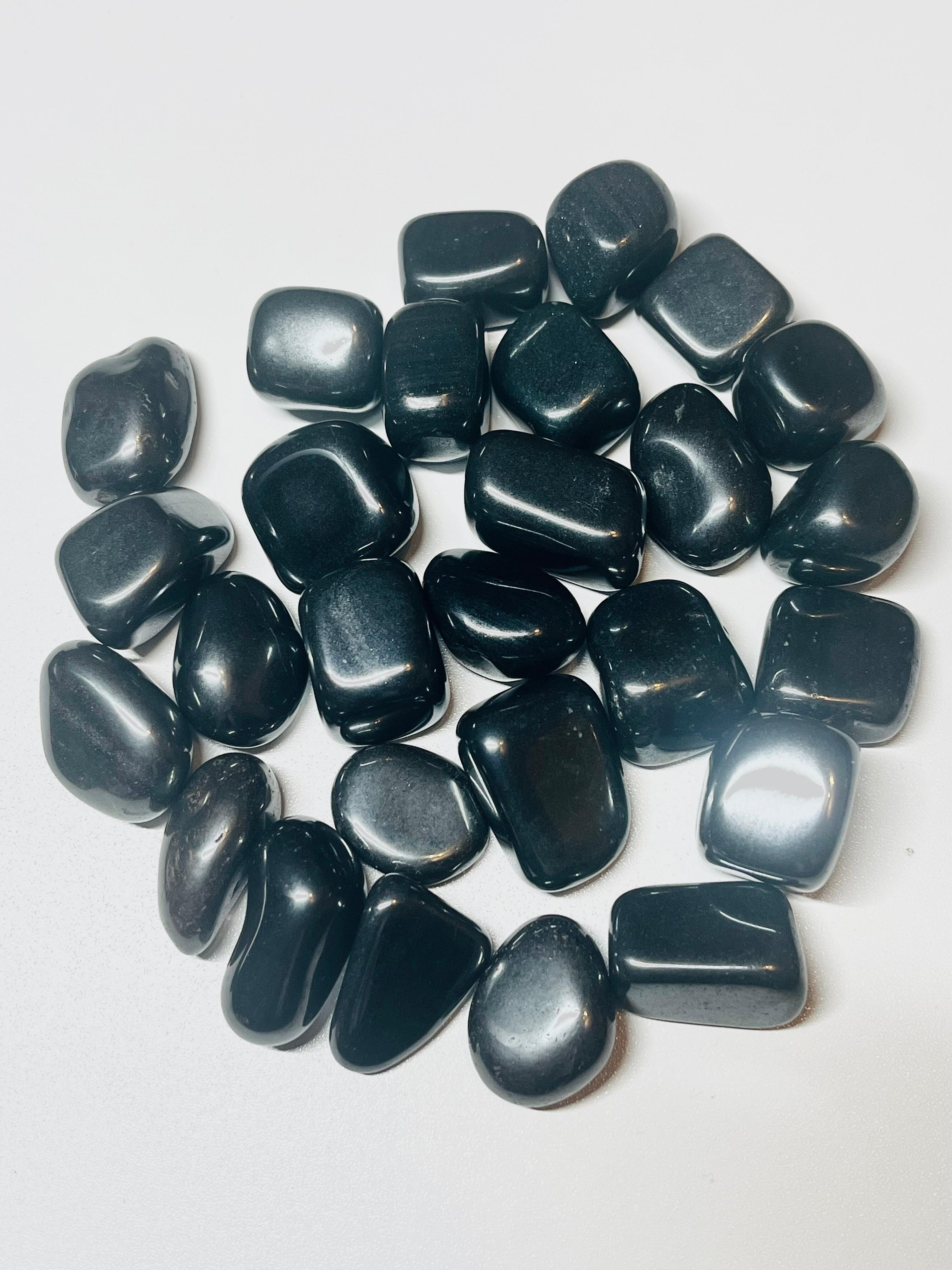 Lots of Hematite Tumbles Crystal Stones on a table