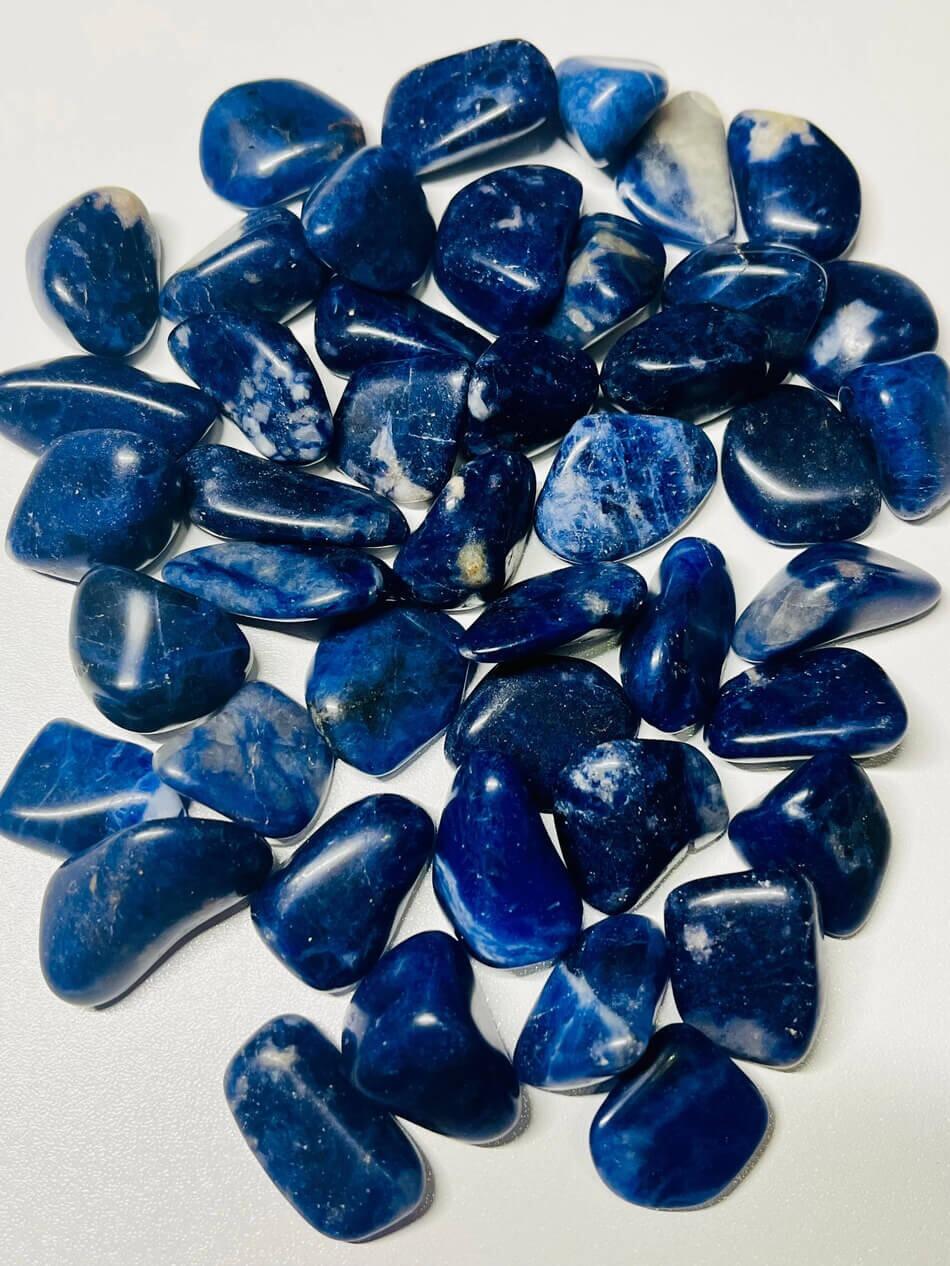 many sodalite tumble healing stone on a table