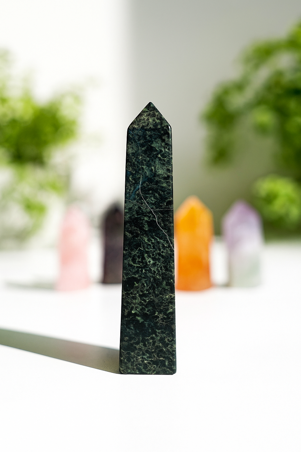 Healerite crystal on a table with different colour crystals all around