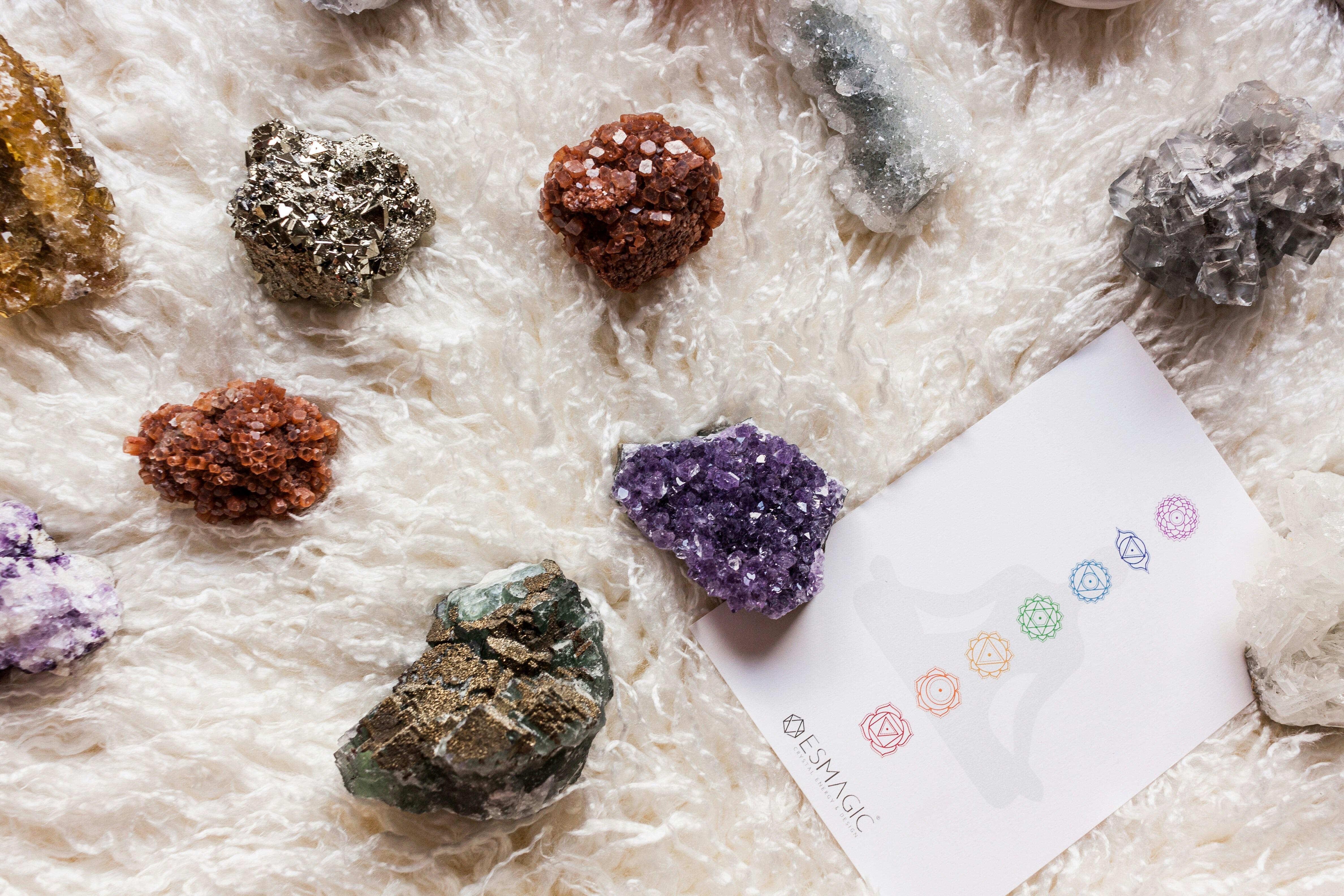 Various crystal types and colours on a table.  Crystals for healing, wellbeing and spiritual growth