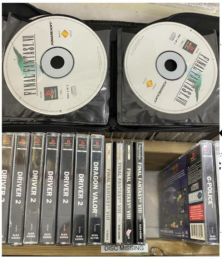 Final Fantasy VII PlayStation discs in wallet above shelf of PS1 game cases with a missing disc tag.