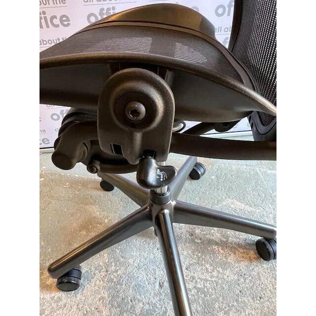 Detail view of Herman Miller Aeron Graphite Size B ergonomic office chair tilt lever