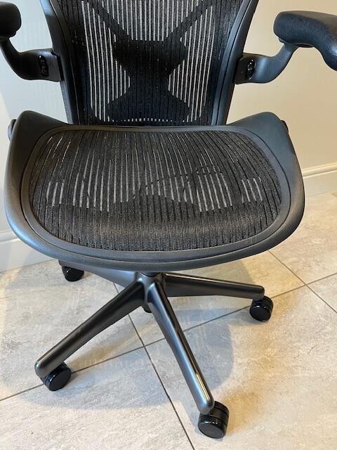 Detailed view of the Elastomeric suspension seat and backrest on a refurbished Aeron chair