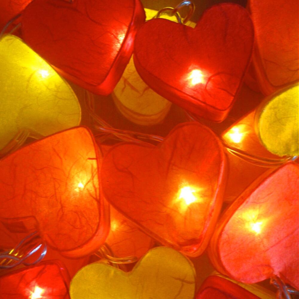 Handcrafted Radiant Heart 20 LED Fairy Lights in the Fire colourway. Hand-screened mulberry paper hearts with warm white LEDs. Mains powered. UK plug included.
