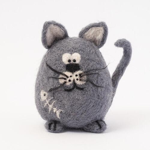 A 3D needle-felted grey cat named Buster with large expressive eyes, a curled tail, and a white needle-felted fish skeleton on his side.