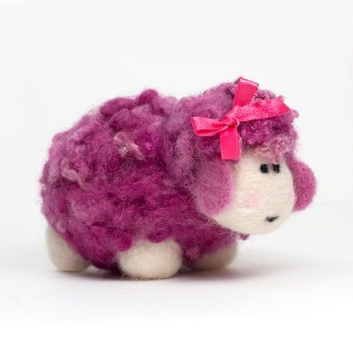 A 3D needle-felted sheep named Flossie with a vibrant pink curly fleece, a white face, and a matching pink satin bow on her head.