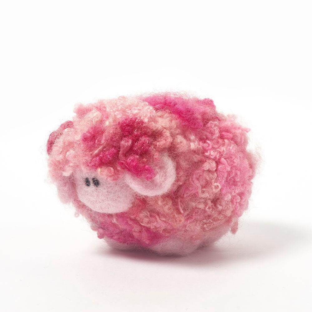 A 3D needle-felted sheep with a thick, curly fleece in variegated shades of strawberry pink.