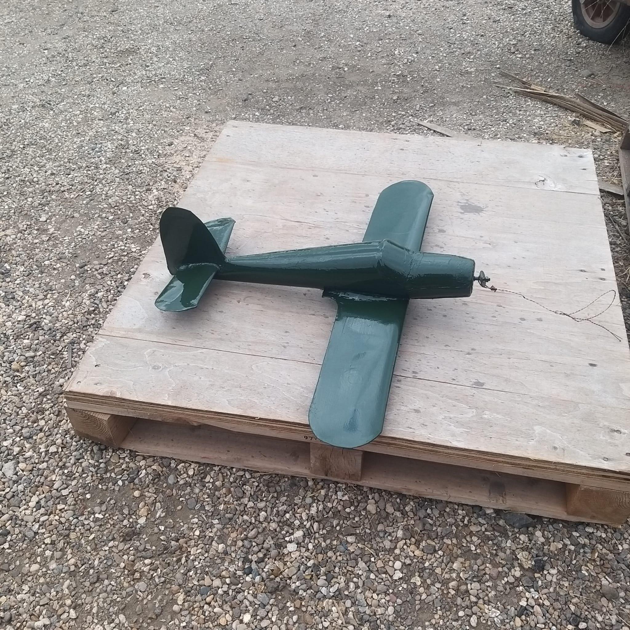 Side view of the primed Spitfire weathervane showing restored fuselage profile before painting