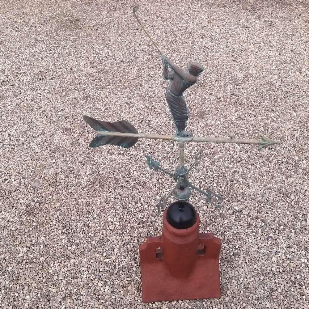Verdigris golfer weathervane installed on a 90 degree ridge tile finial