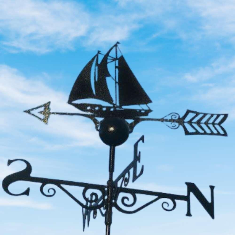 Sailboat weathervane installed on a half round roof ridge finial
