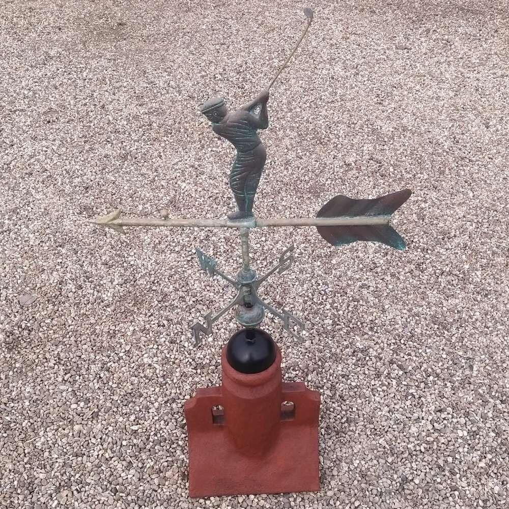 Verdigris golfer weathervane installed on a 90 degree ridge tile finial