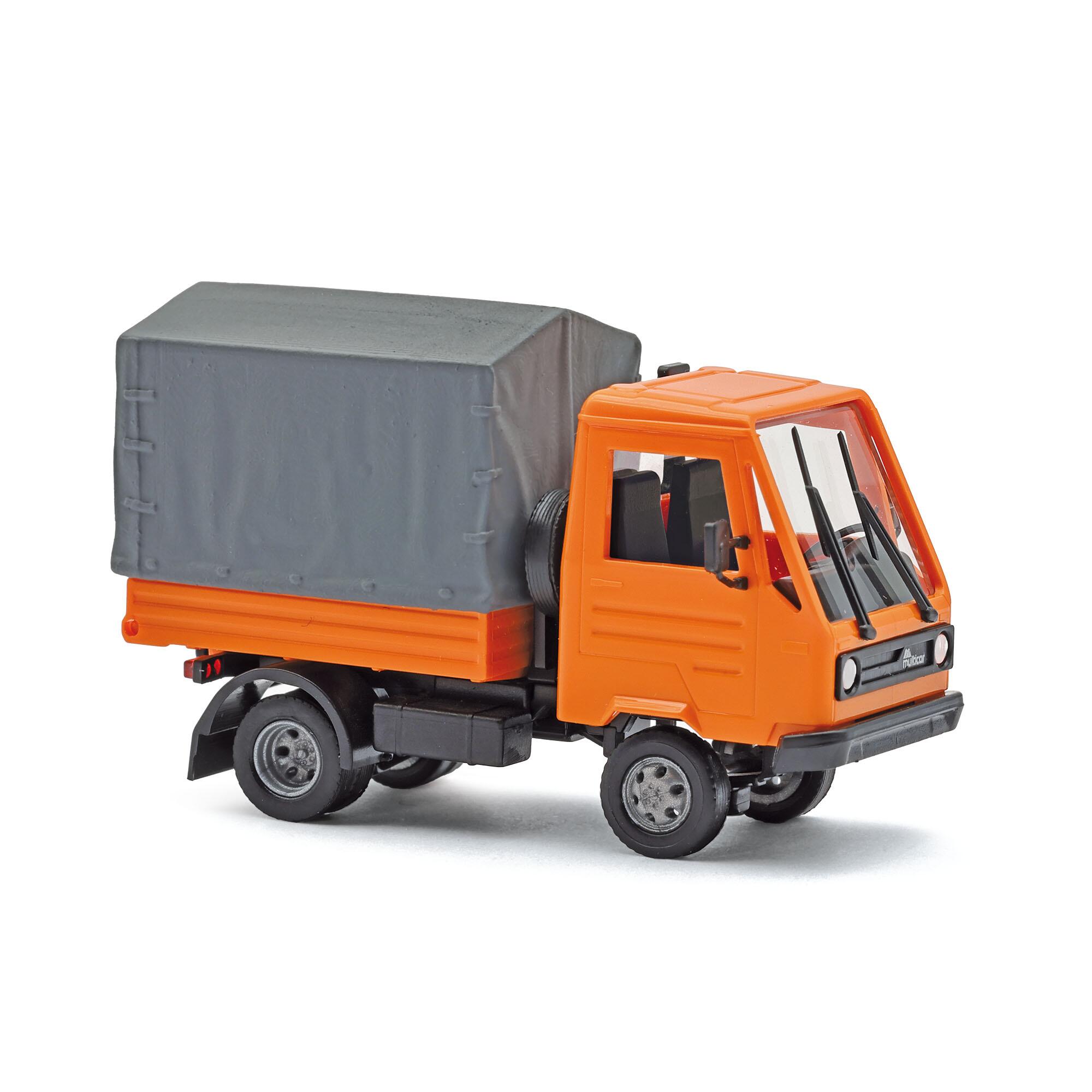 Busch 42253 Multicar M26 with flatbed/tarpaulin, orange