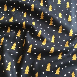 Christmas fabric with gold pine trees on black