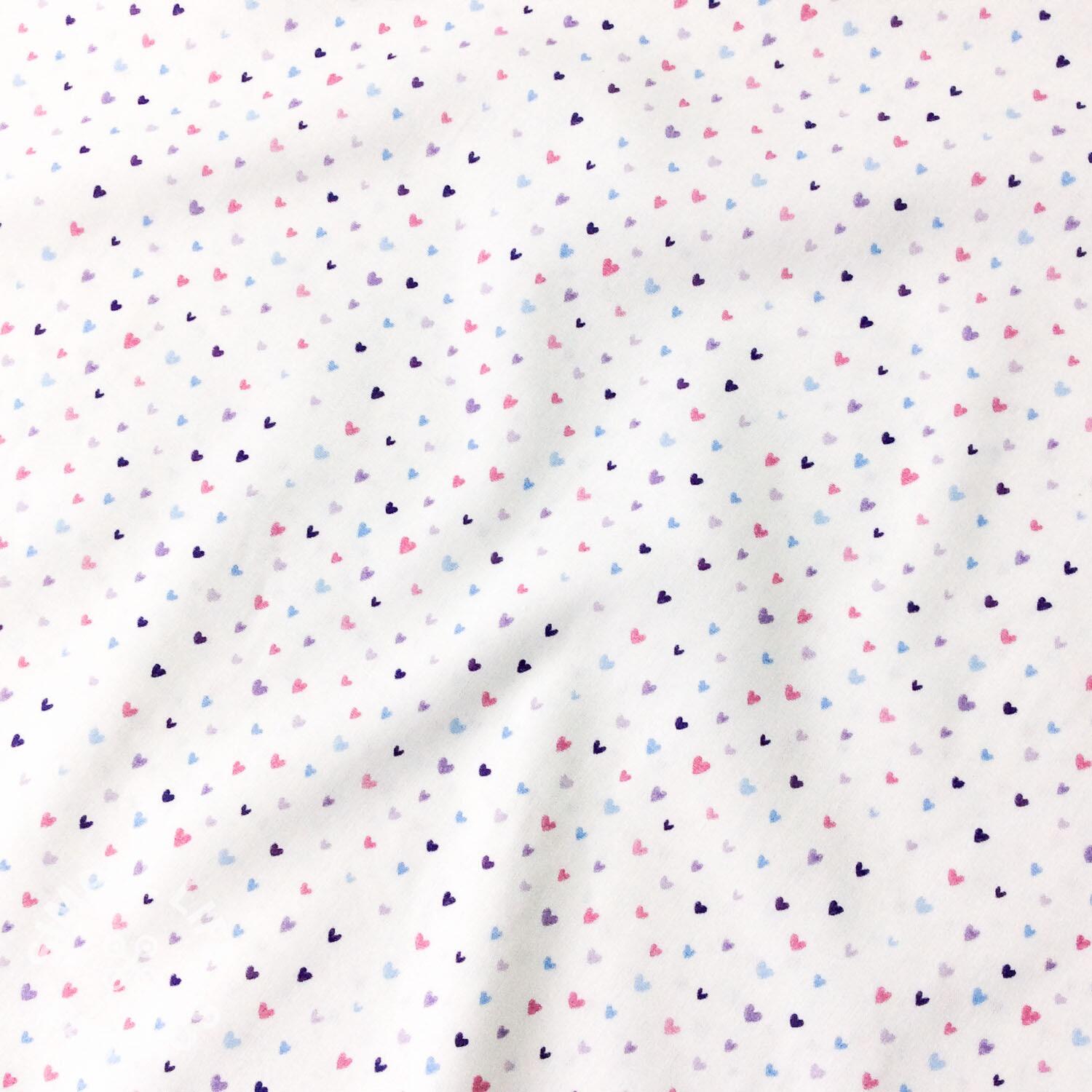 Tiny hearts on white cotton fabric