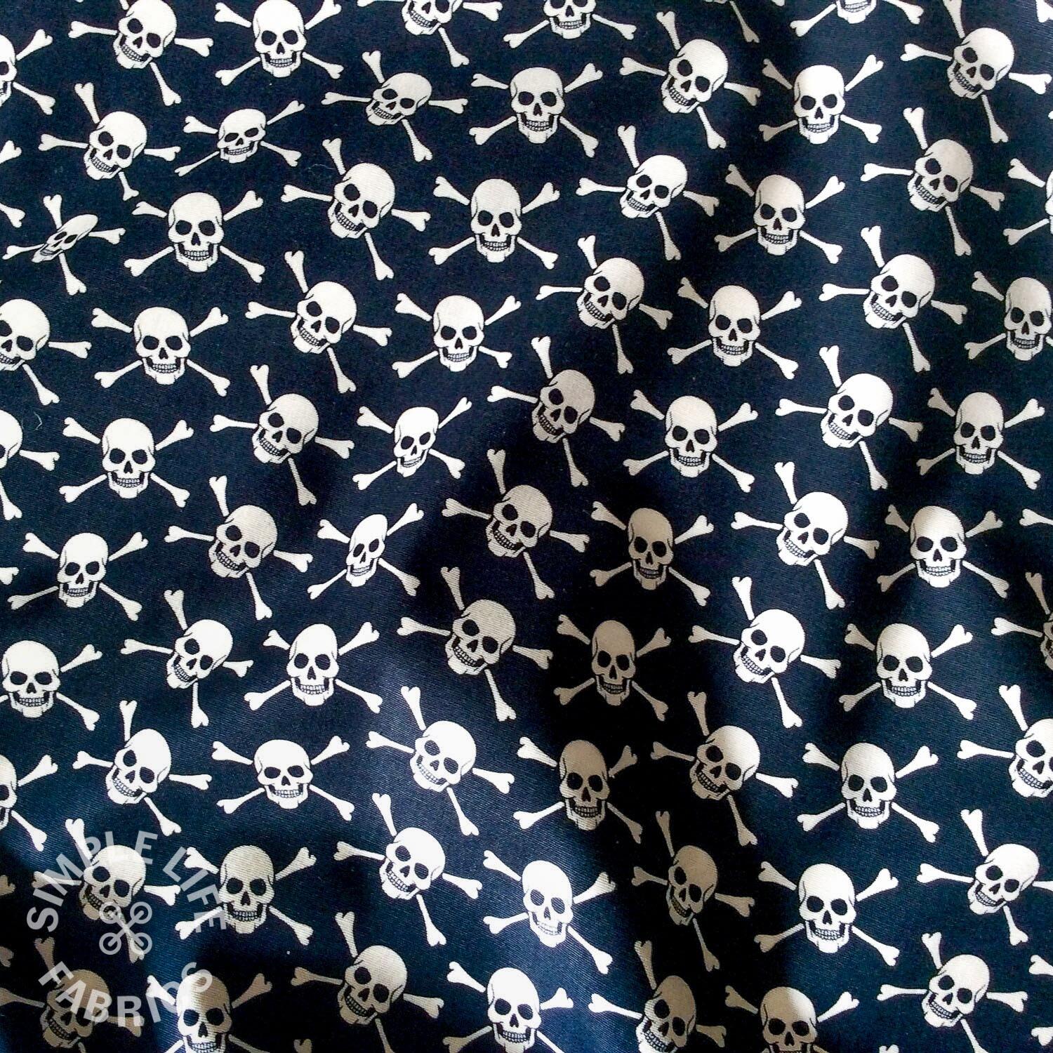 Ditsy skulls and crossbones cotton fabric