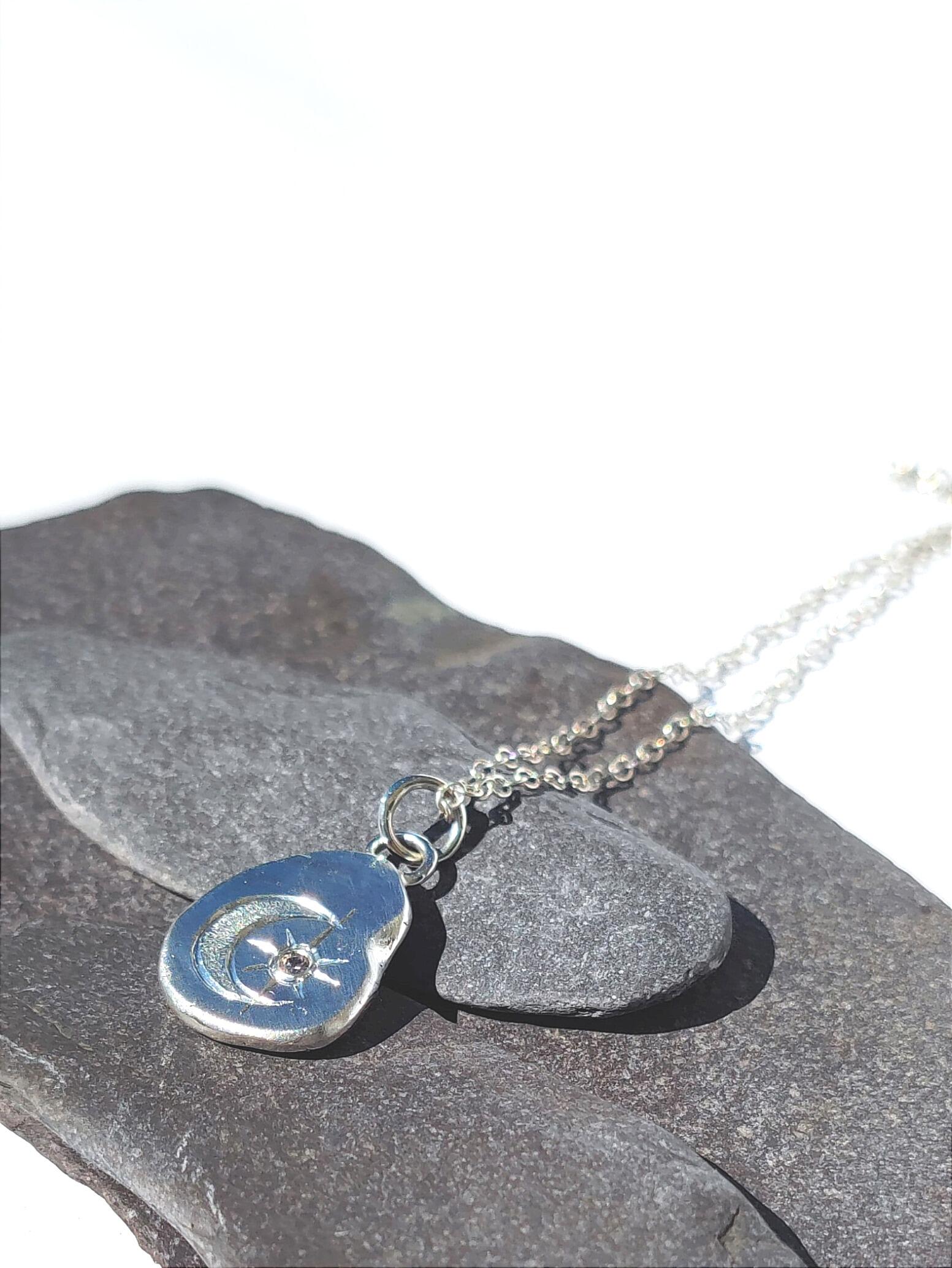 Pebble Pendant with hand engraved Moon and Stars design and 2mm Cubic Zirconia, handmade with recycled sterling silver.