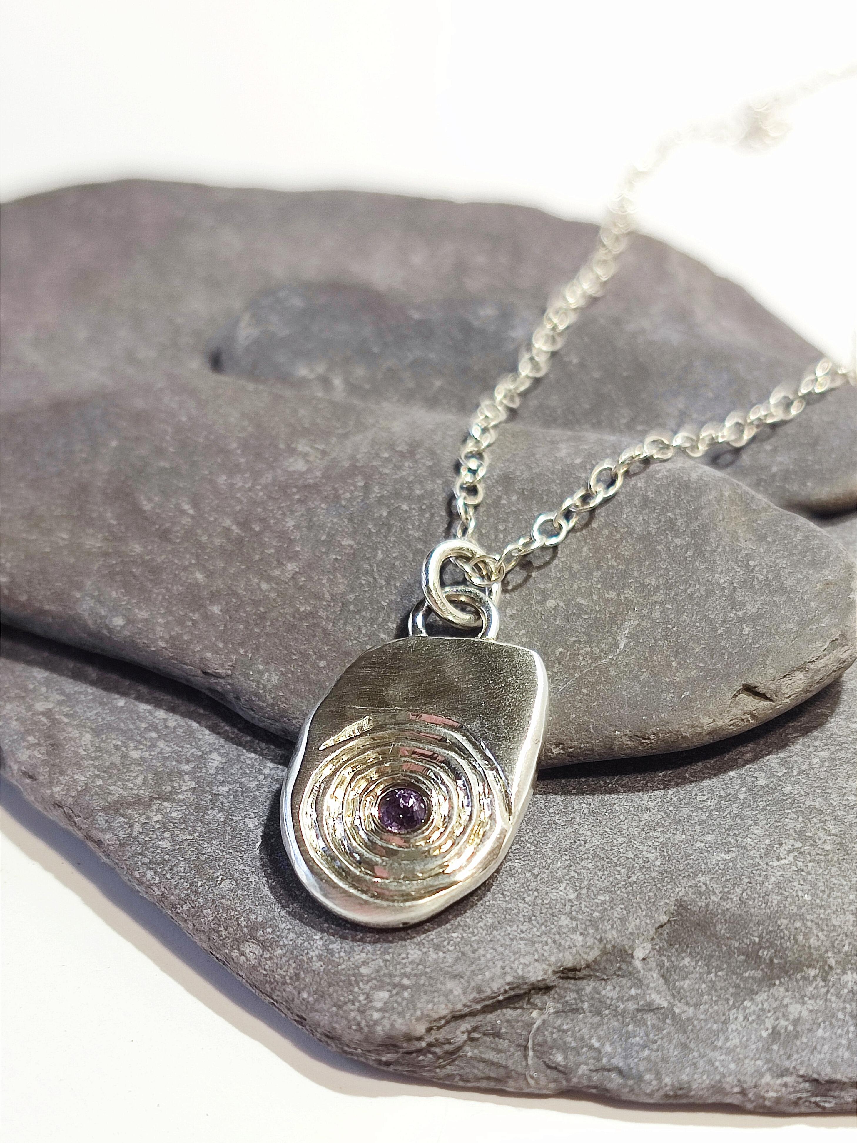 Pebble Pendant with hand engraved Spiral design and 2.7mm Amethyst, handmade with recycled sterling silver.