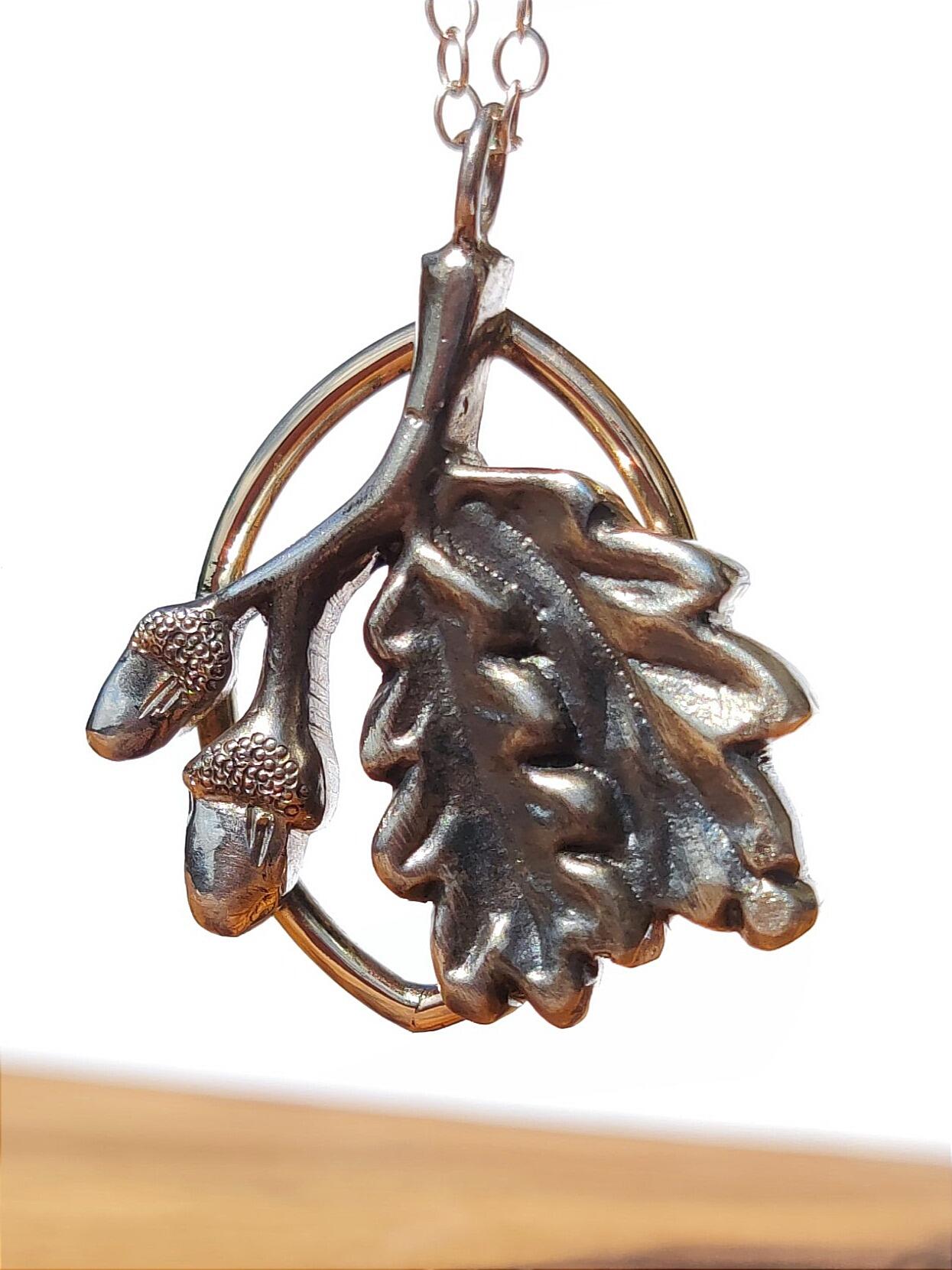 Oak Branch Pendant with leaves and acorns handmade in sterling silver.