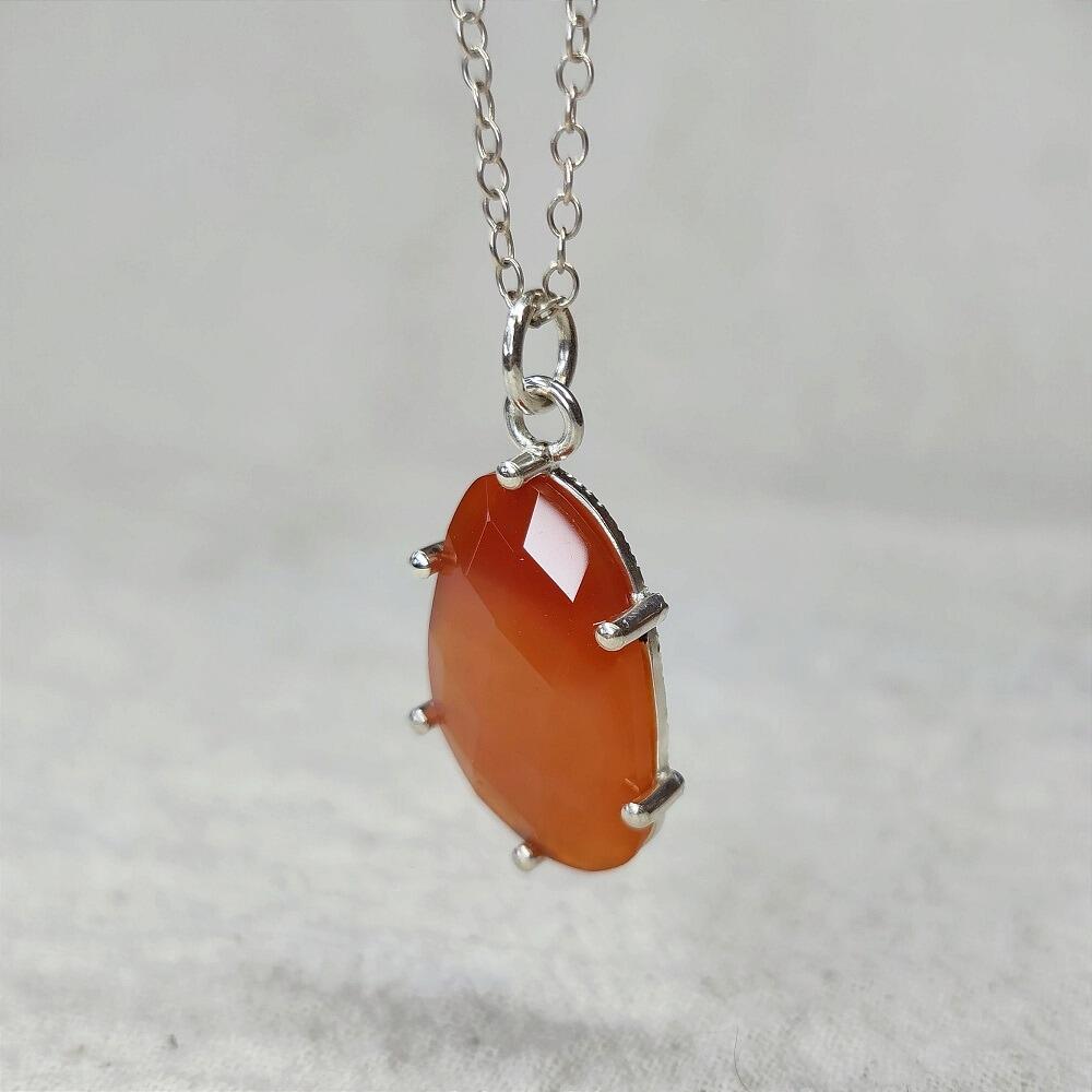 Freeform Checkerboard Carnelian Pendant with starburst engraving on the reverse