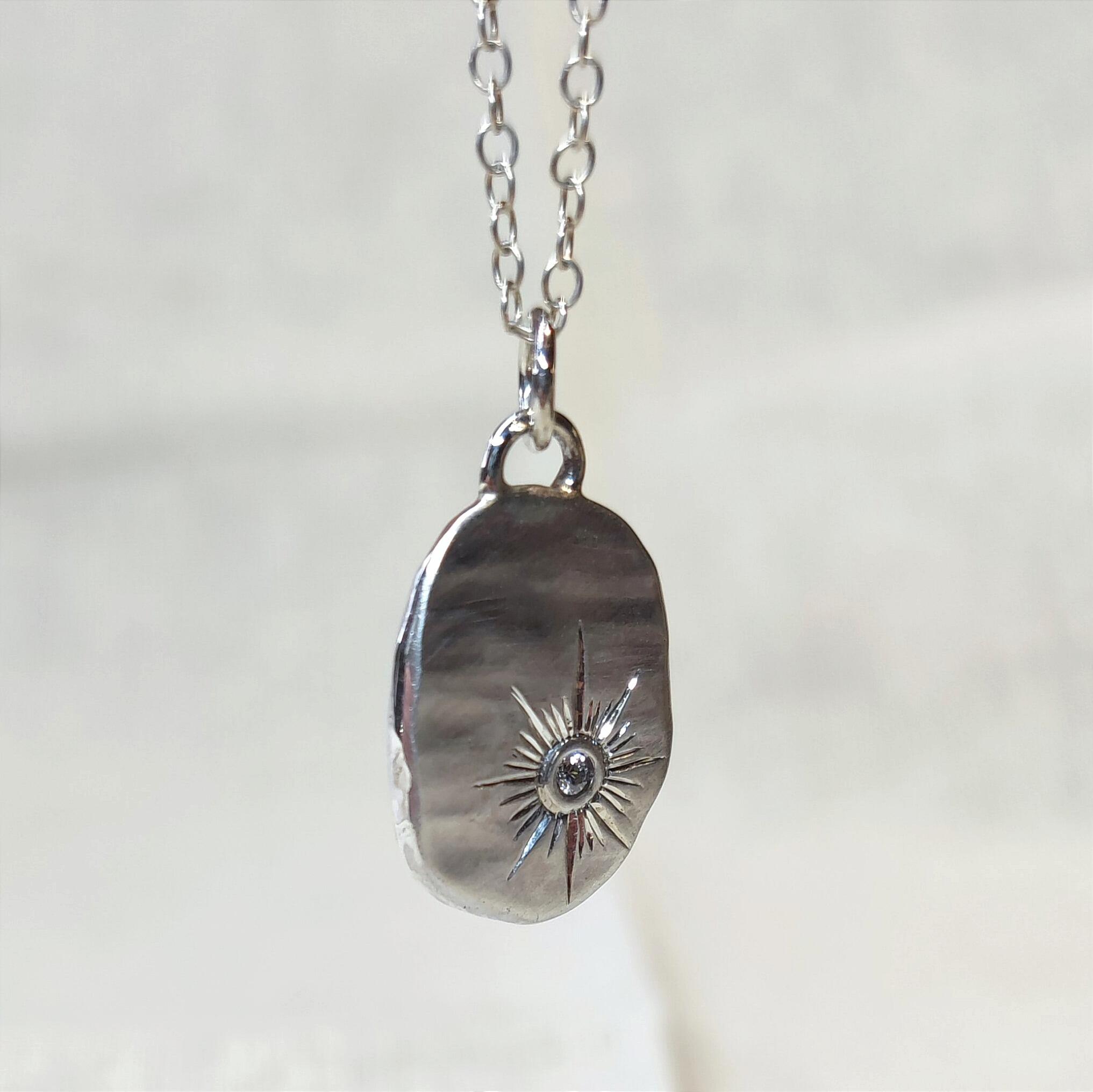 Pebble Pendant with hand engraved Sun design and 2mm Cubic Zirconia, handmade with recycled sterling silver.