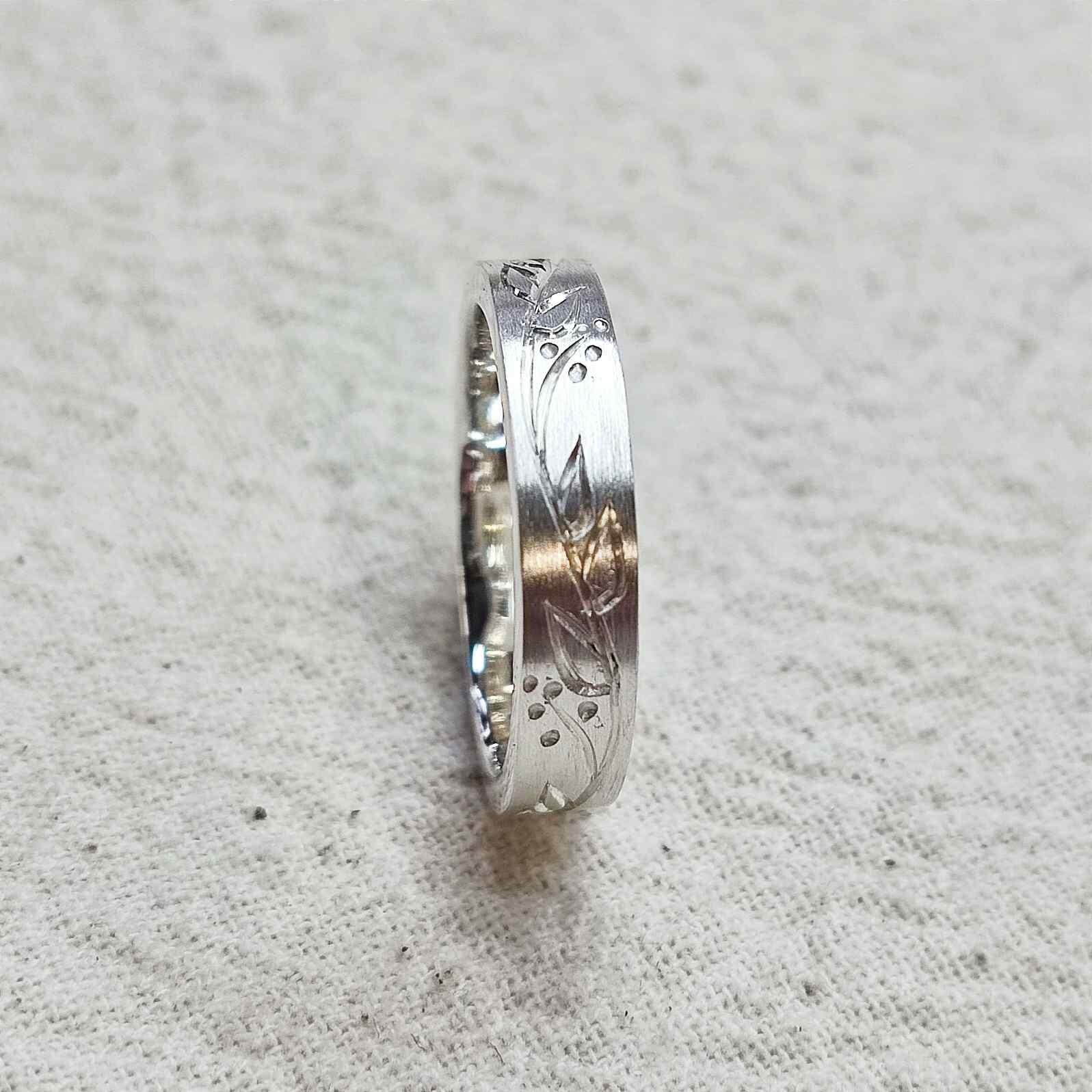 Hand engraved sterling silver floral band with brush finish