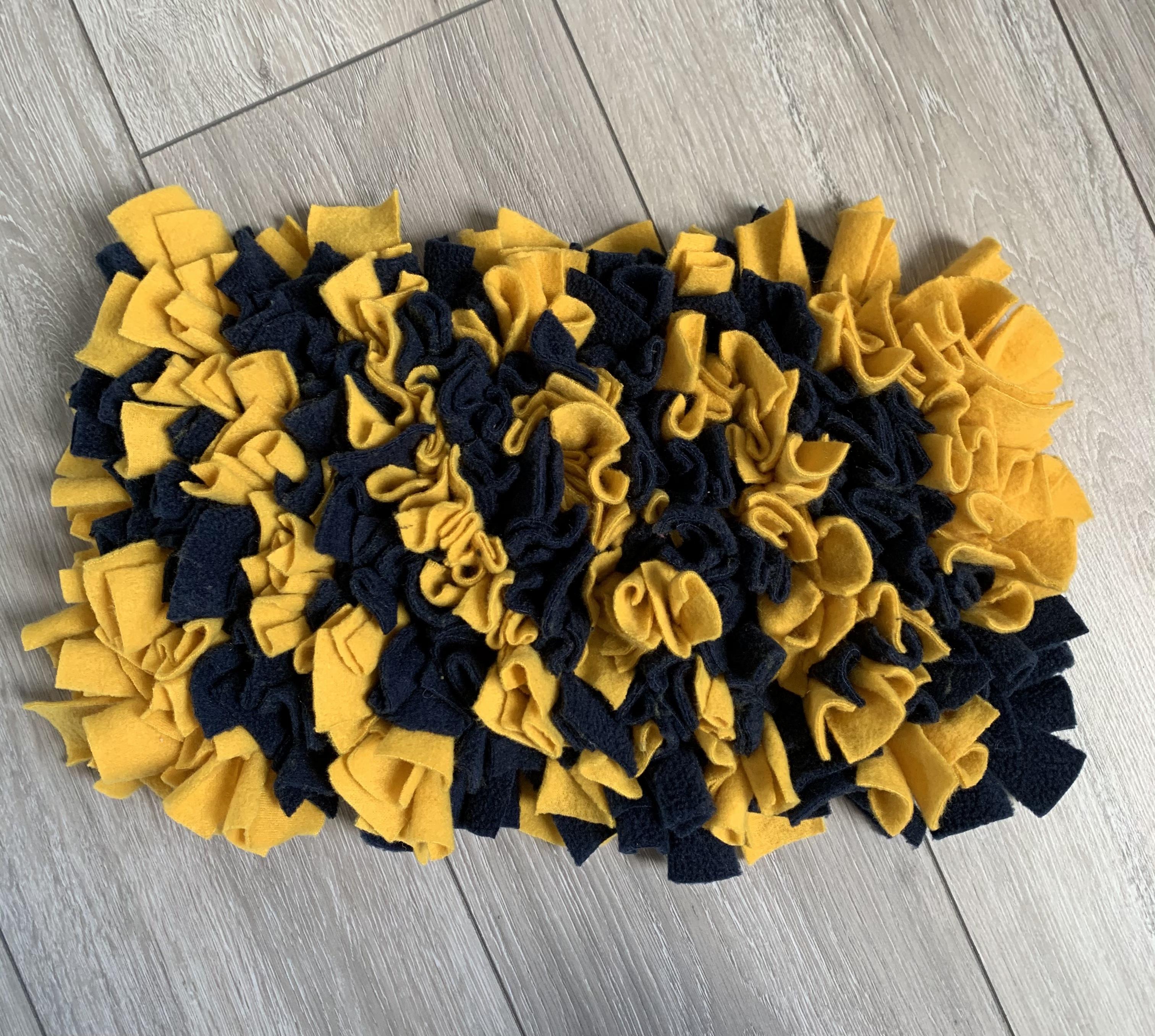 two dogs feeding off snuffle mat