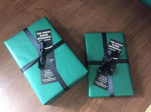 some green wrapped parcels with black ribbon