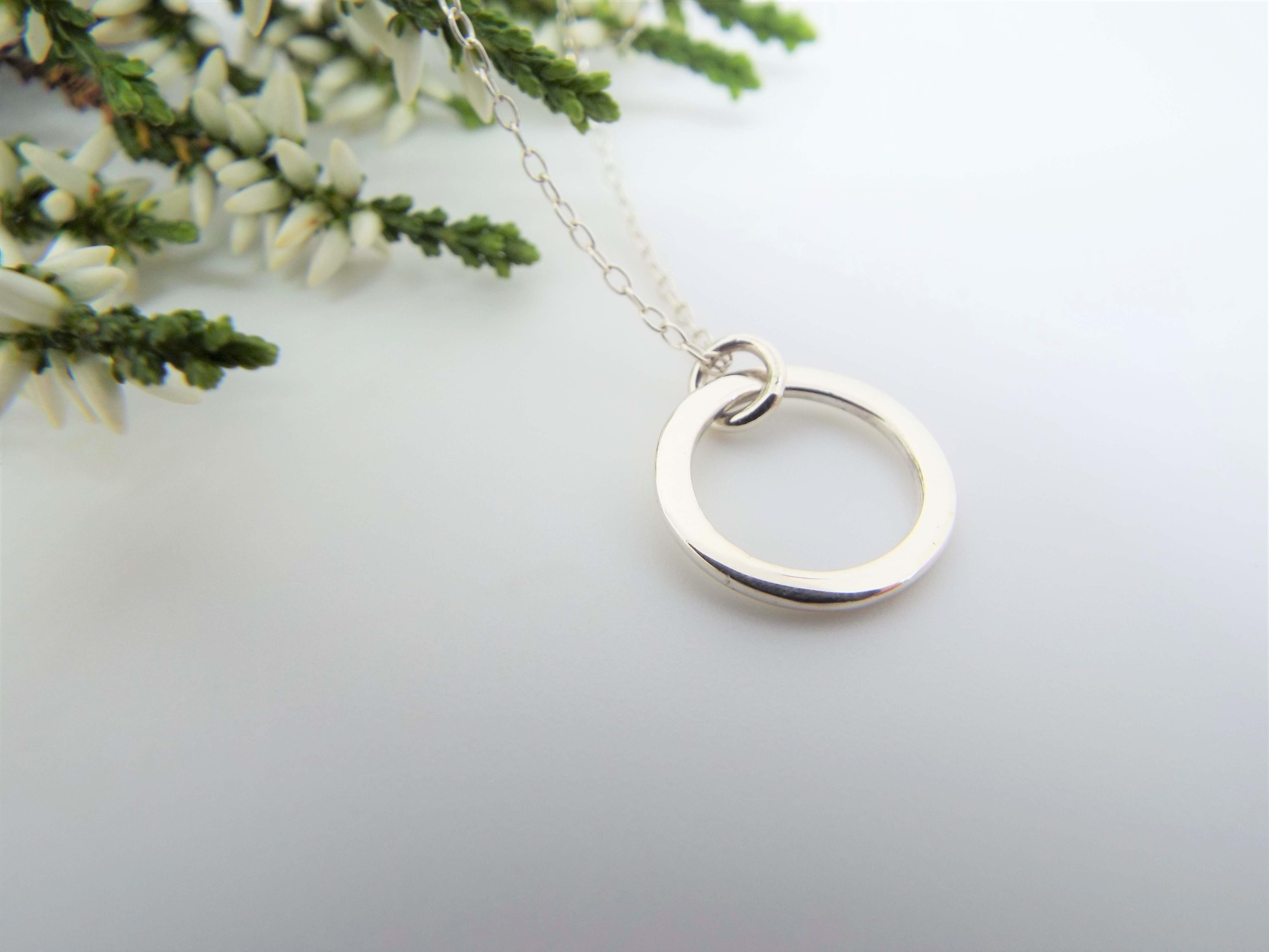 dainty silver circle pendant necklace on a chain
