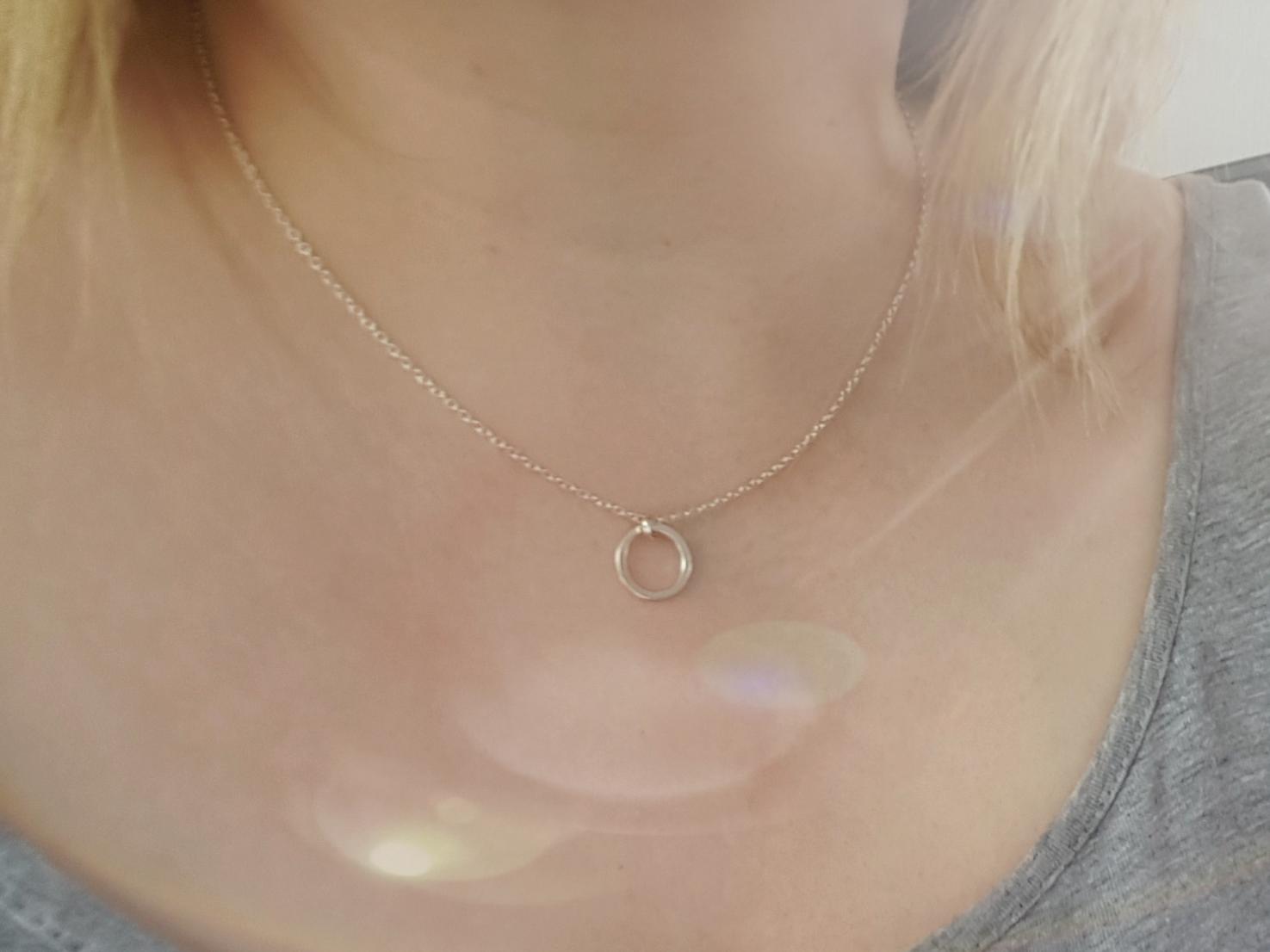silver circle pendant necklace being worn