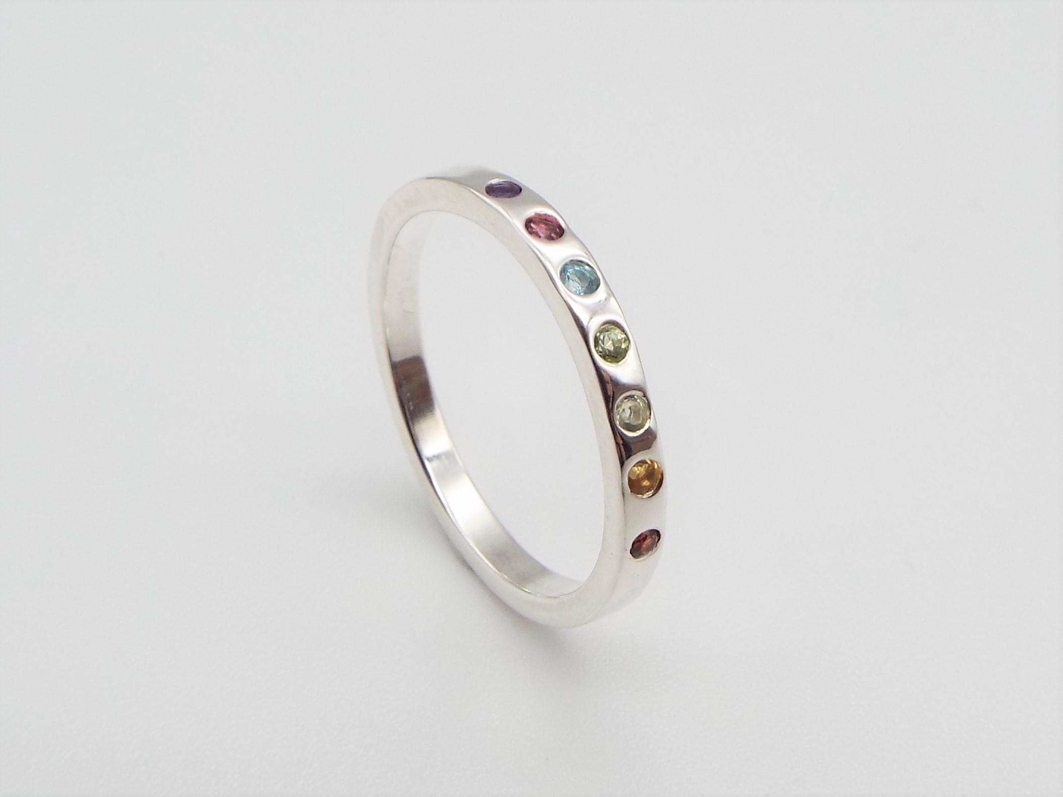 silver ring set with rainbow gemstones
