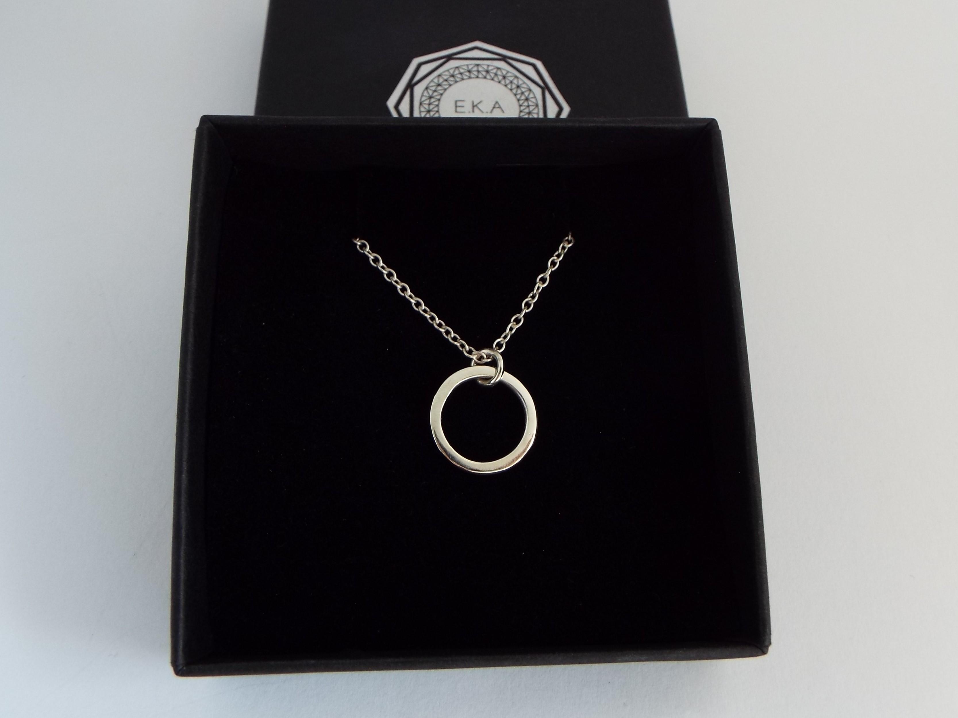 dainty silver circle pendant necklace on a chain in a gift box