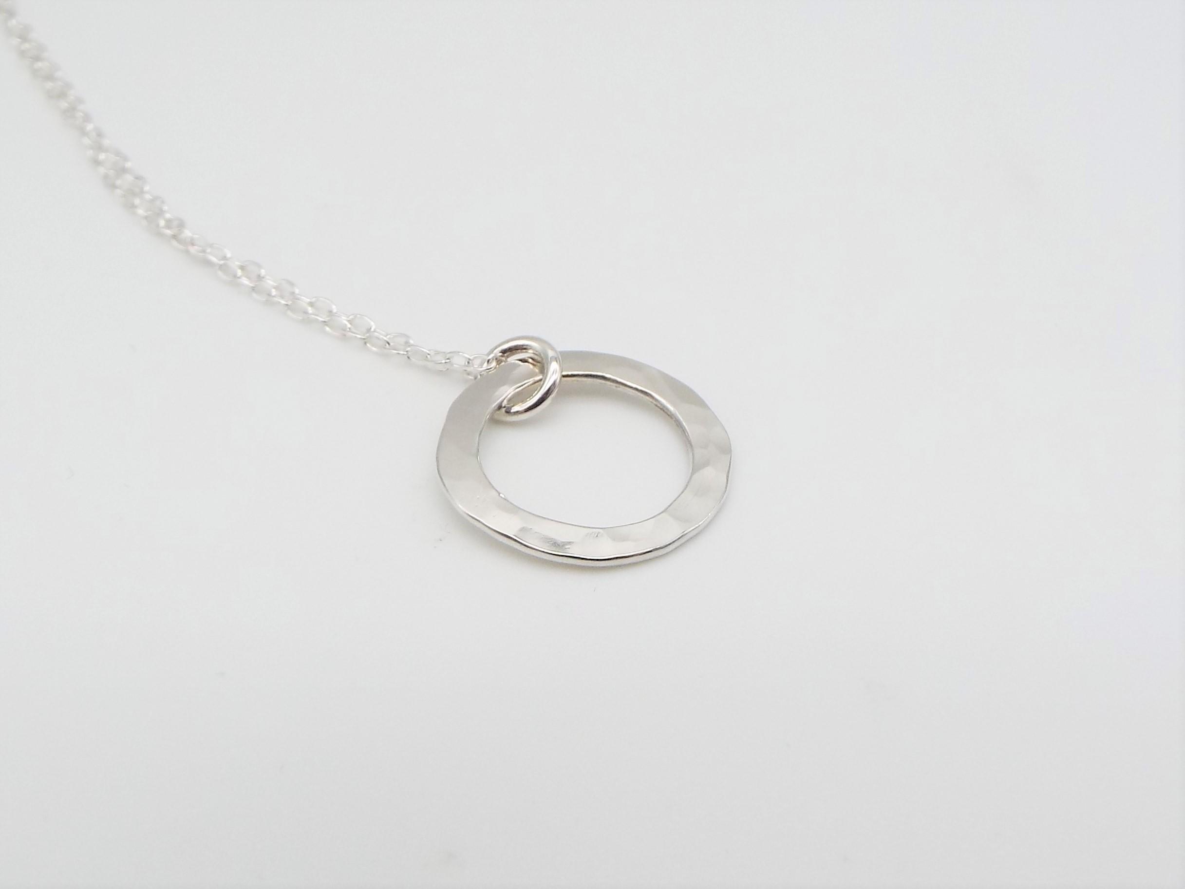 silver circle necklace with a hammered finish