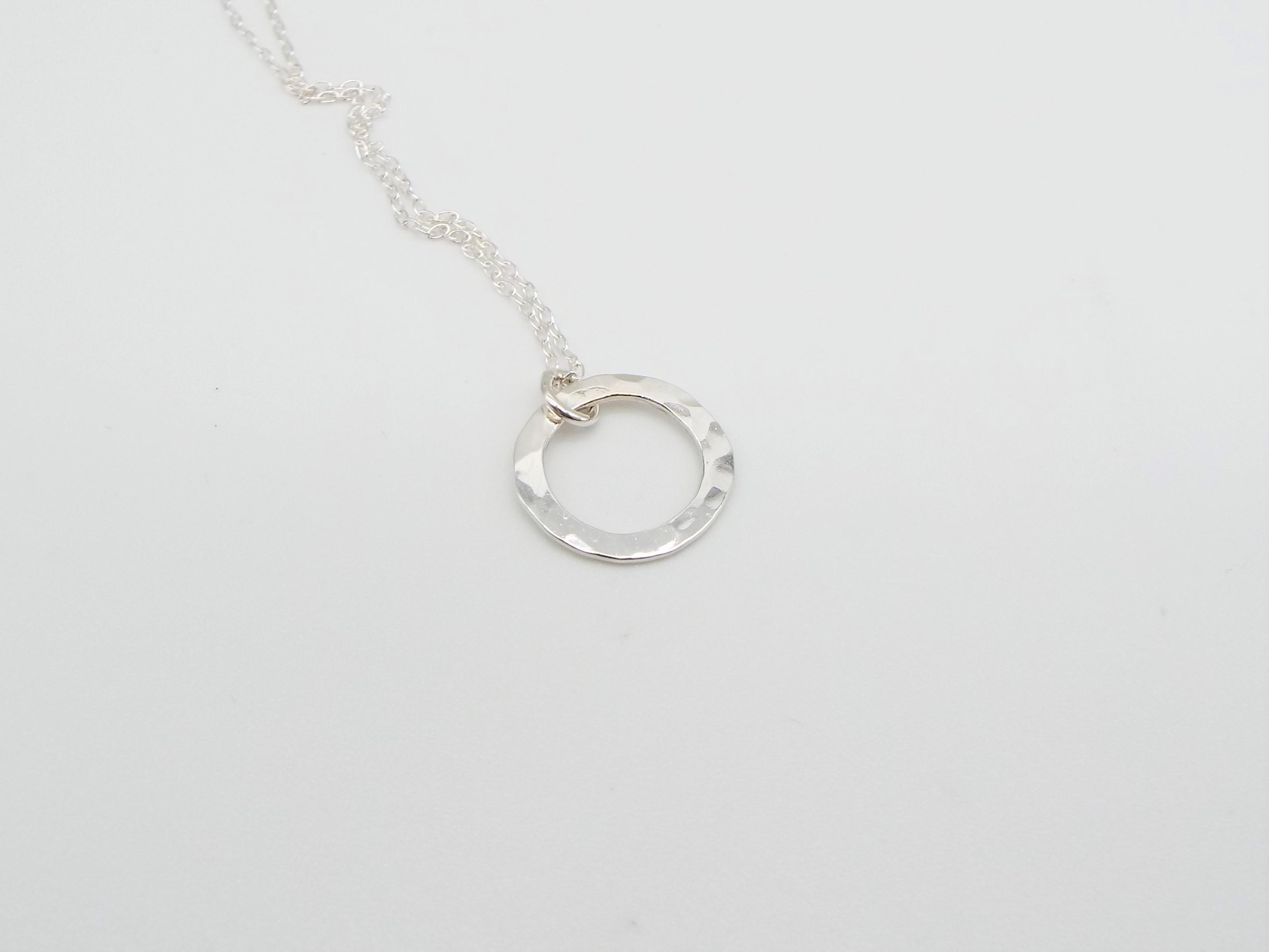 silver circle necklace with a hammered finish