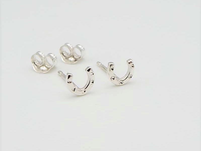 little silver earrgins shaped like lucky horsehoes