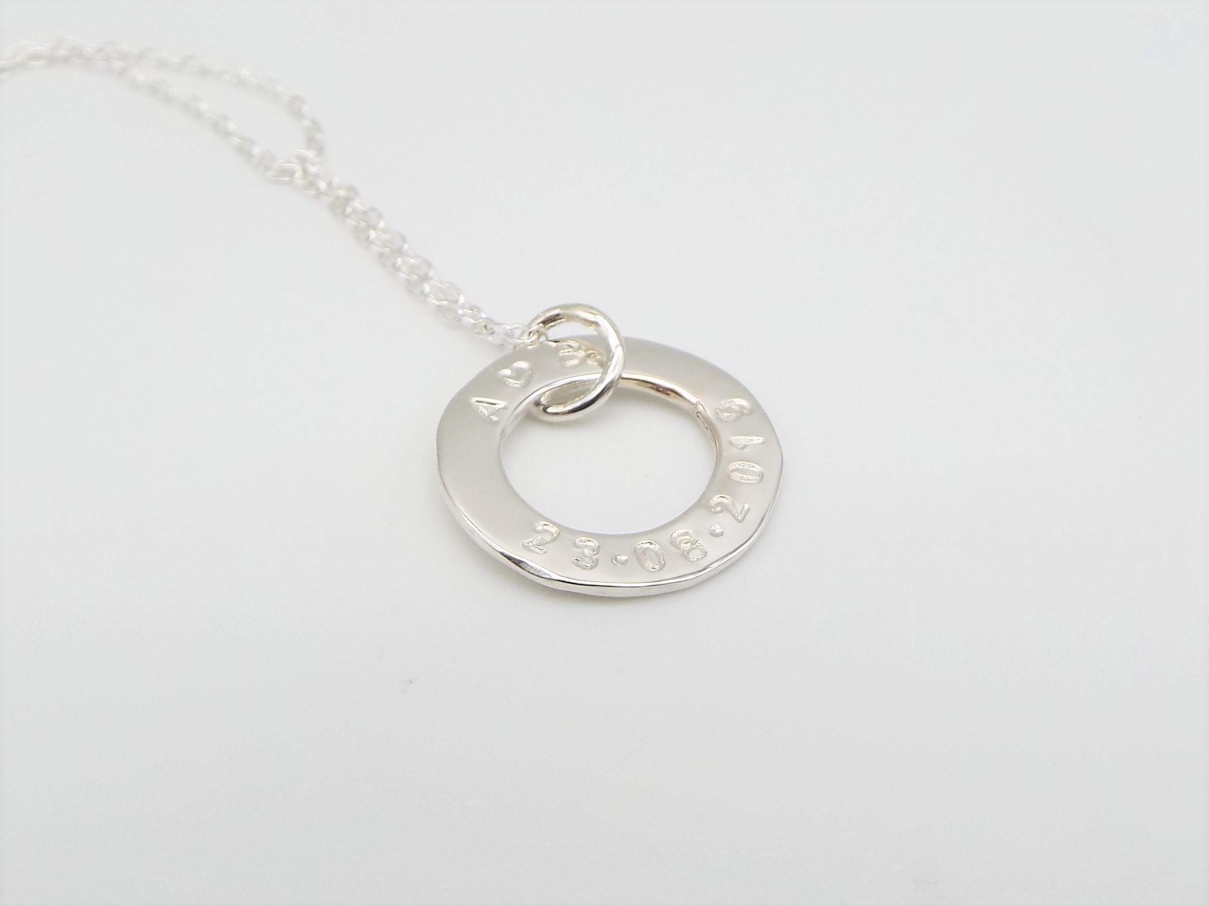 silver circle necklace stamped with name and special date
