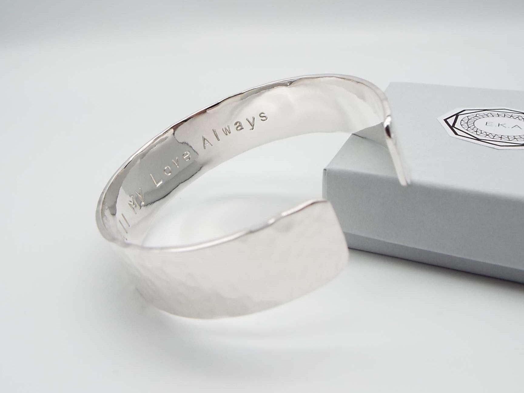 handmade silver cuff bracelet with a hammered finish stamped with the words love always