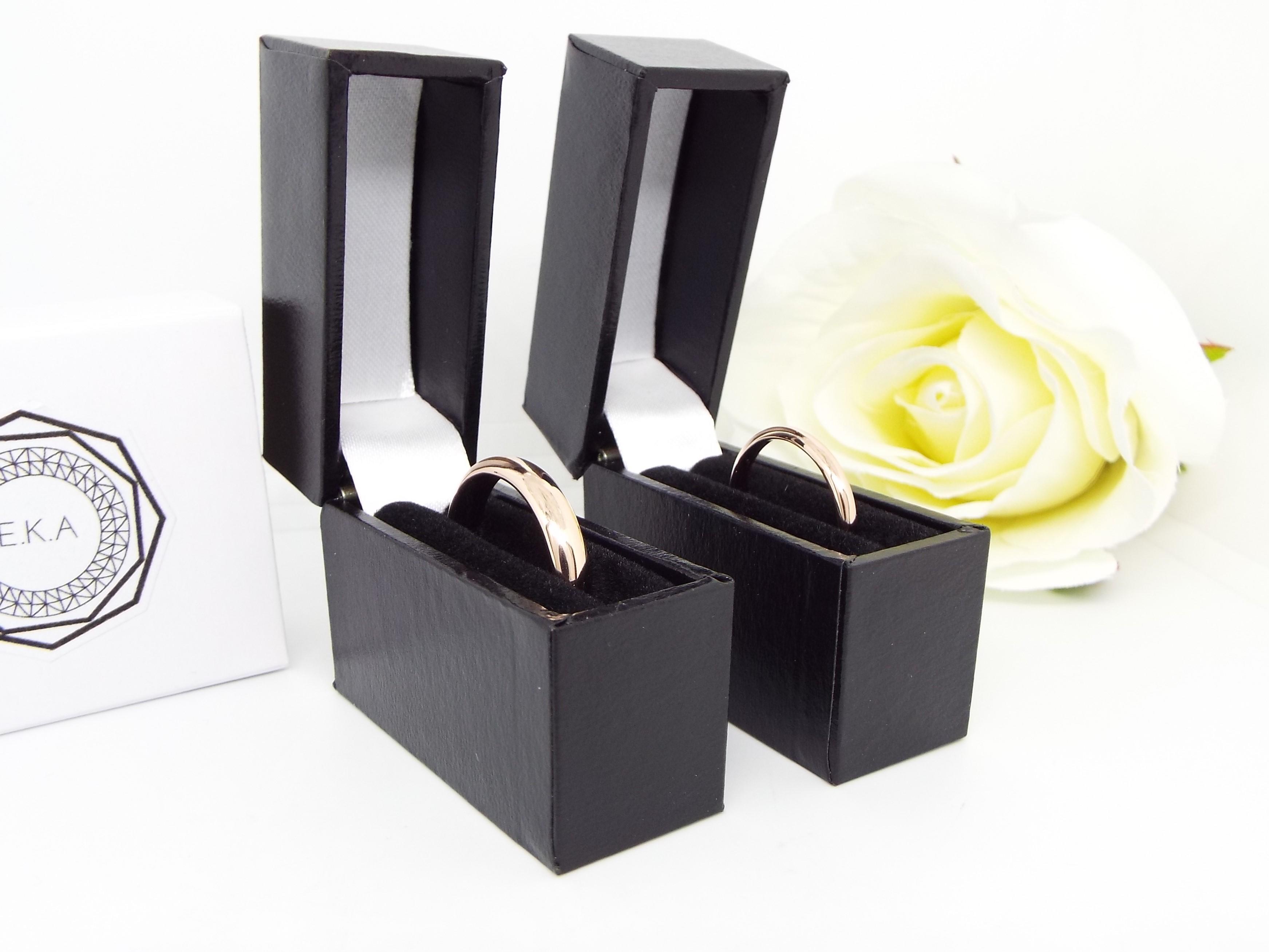 set of his and hers wedding rings in ring boxes