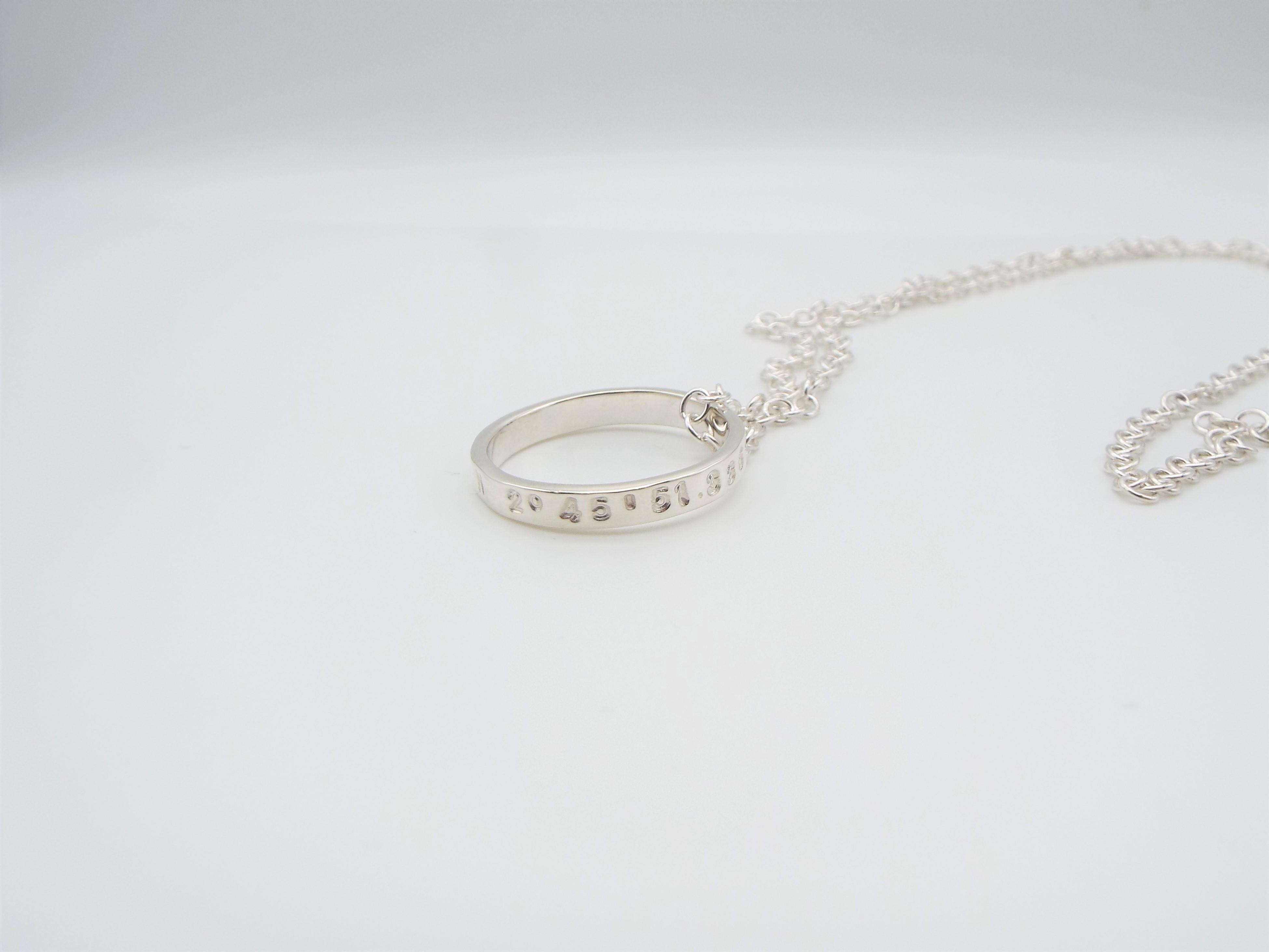 silver ring on a chain