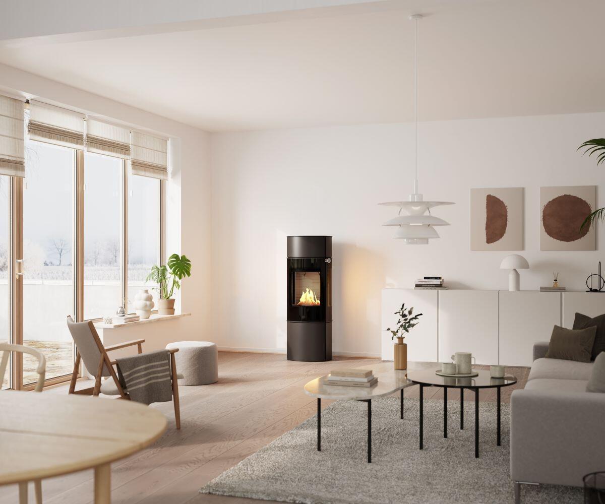Rais Caro 130 Bio stove in an open living and dining space with wall art