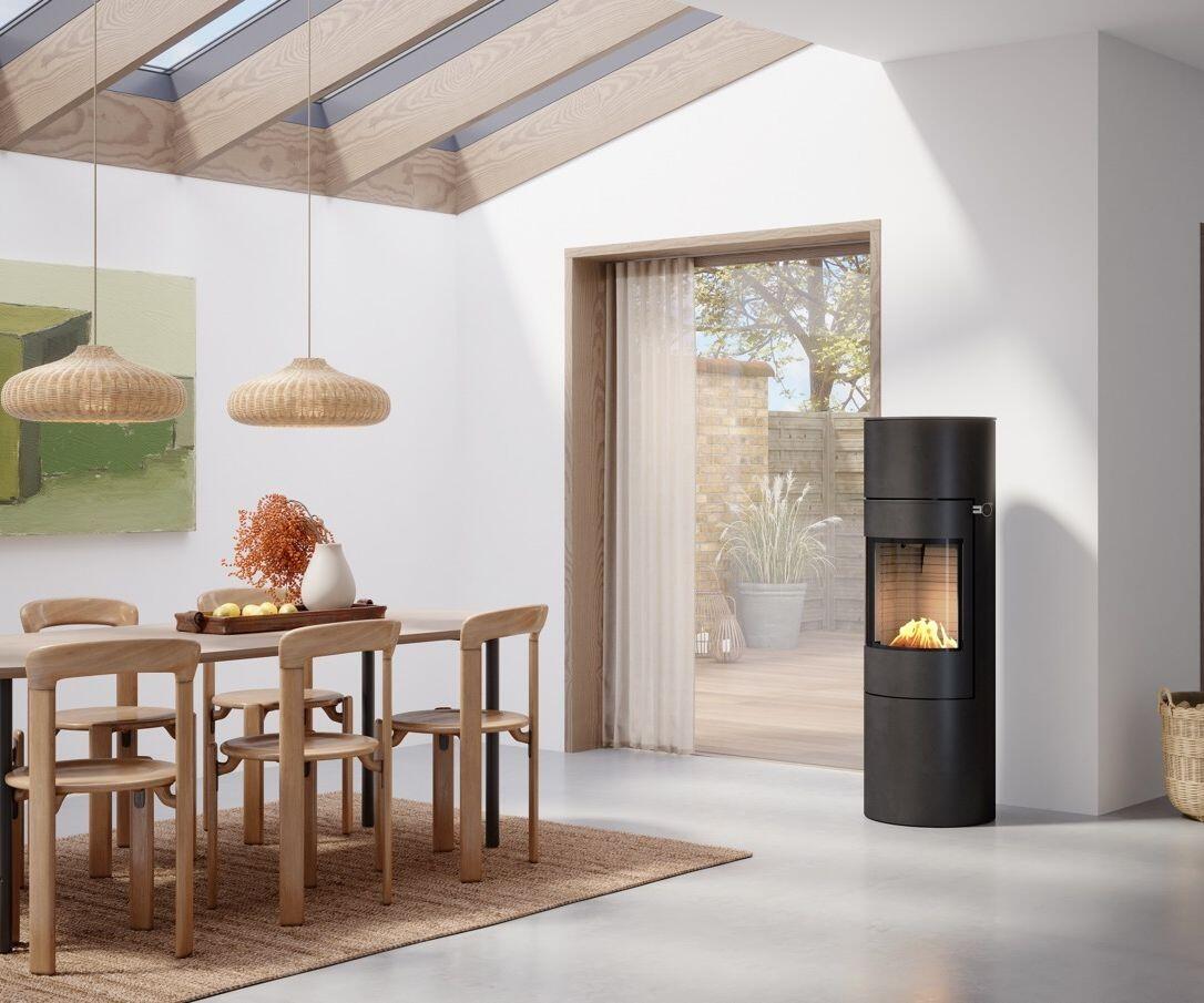Rais Viva L 140 Bio stove in a bright dining room with a timber ceiling