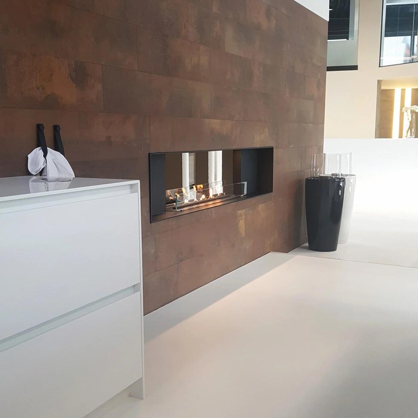 Montreal Panorama see-through fire in a rust-effect wall beside a white kitchen