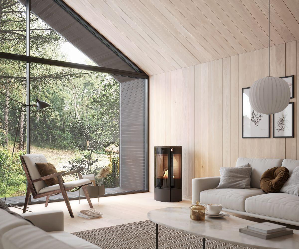 Rais Caro 90 Bio compact bio stove in a living room with a forest view