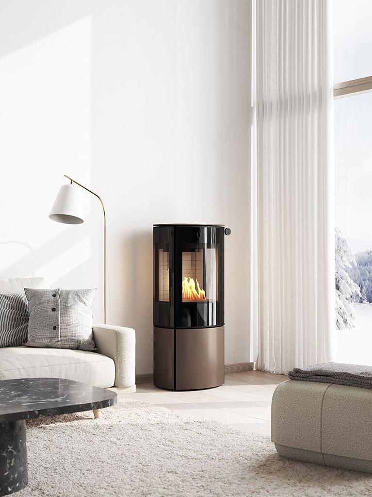 Rais Caro 110 Bio bioethanol stove in a bronze-toned finish beside a white sofa