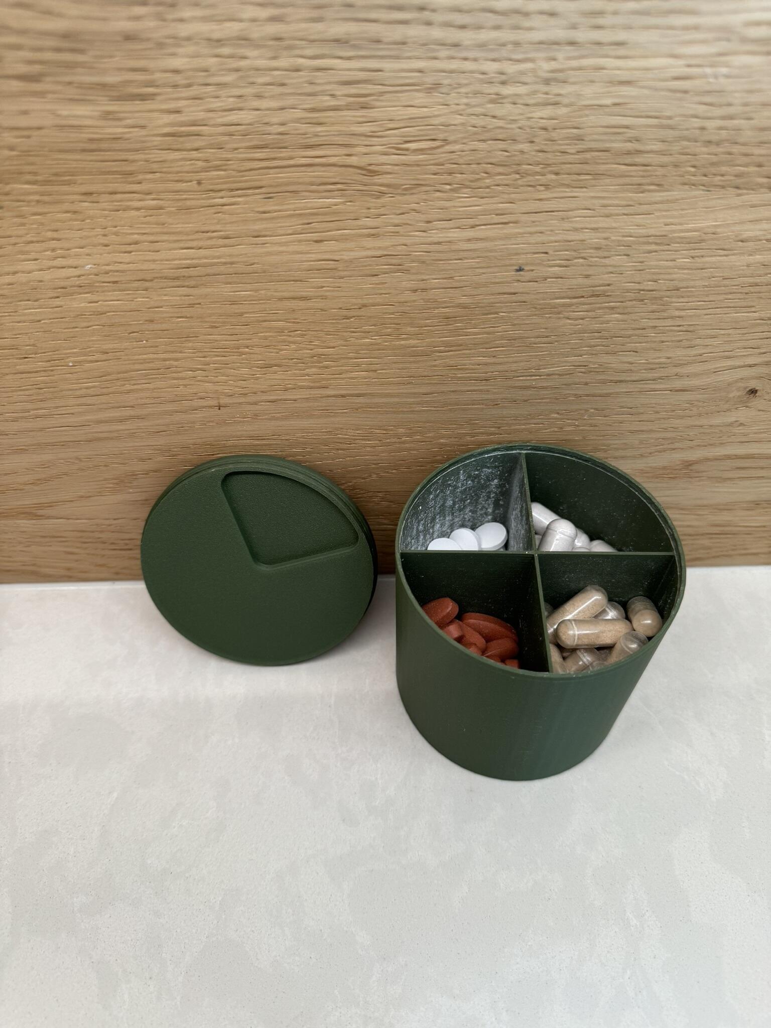 Green 3D printed cylindrical medical pill tablet container with four quartered sections