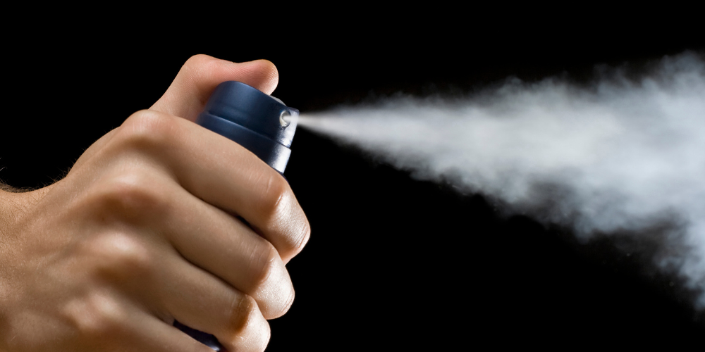 Man spraying Antiperspirant