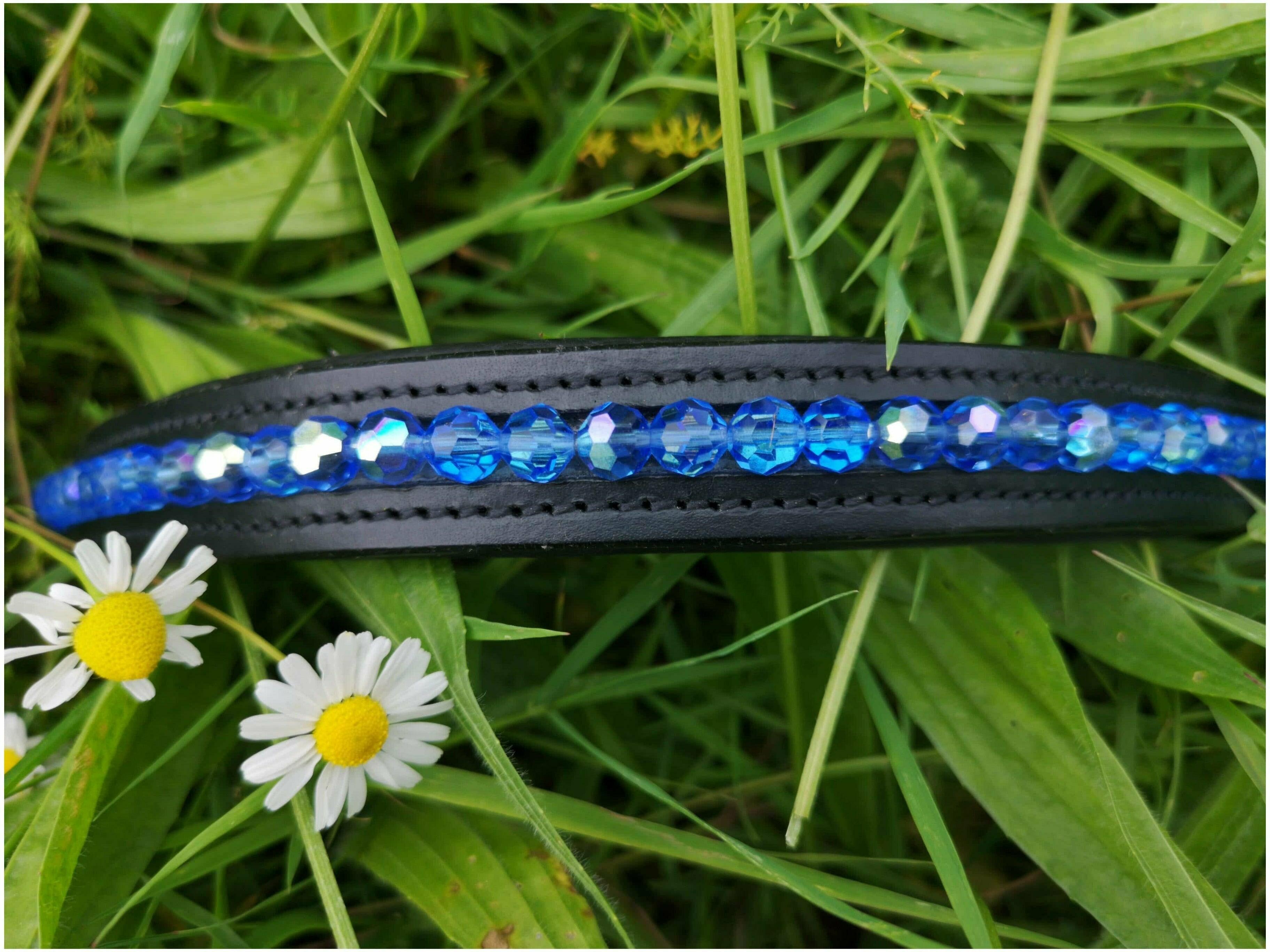Amazing quality custom browband sitting on a bed of grass surrounded by daisy's